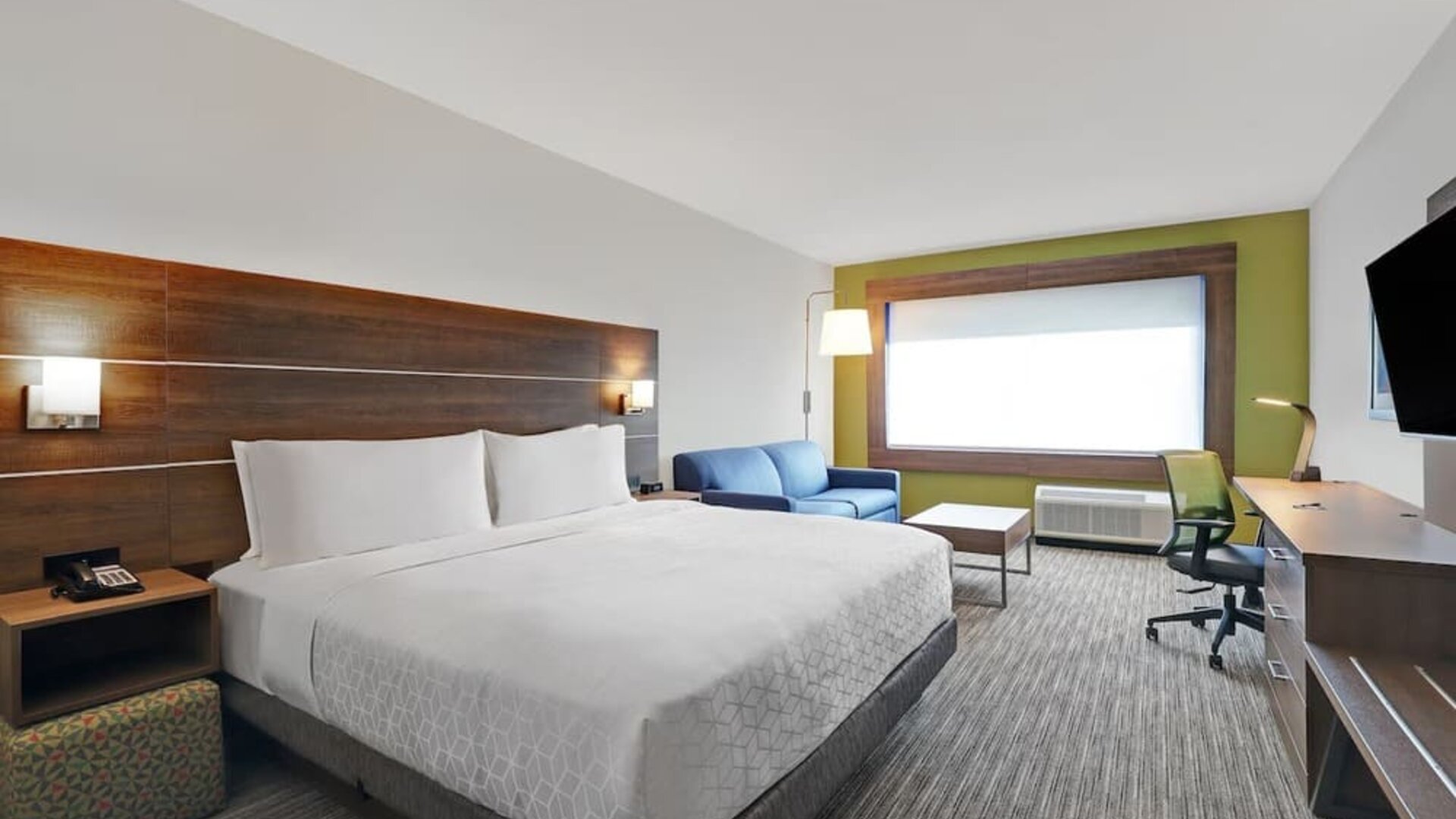 Day use room with TV, sofa, work desk and private bathroom at Holiday Inn Express Kingston West.