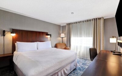 Day use room with TV, sofa, work desk and private bathroom at Four Points By Sheraton Toronto Mississauga.