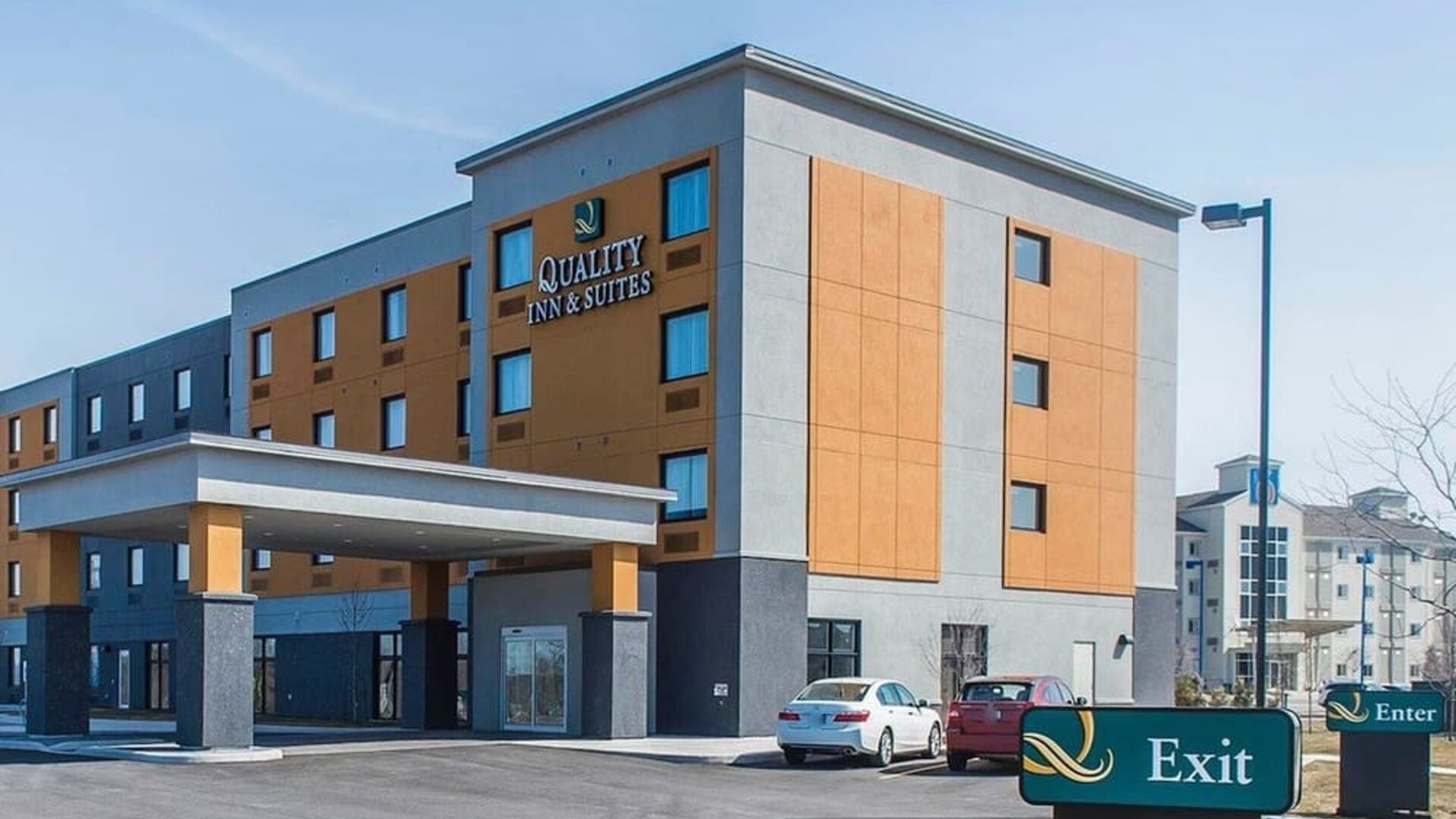 Hotel exterior with parking area at Quality Inn & Suites Kingston.