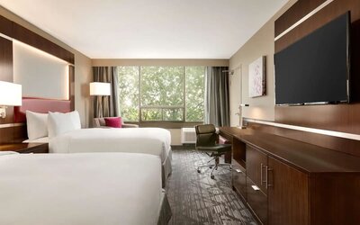 Day use twin room with large windows, TV, sofa, work desk and private bathroom at DoubleTree By Hilton Hotel Toronto Airport West.