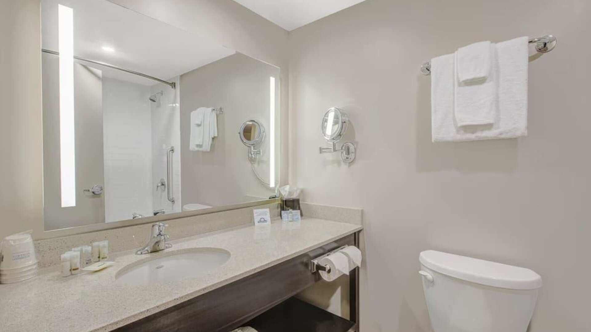 Private guest bathroom with shower and free toiletries at Days Inn & Suites By Wyndham Lindsay.