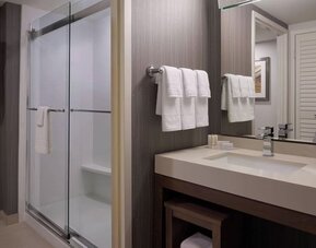 Private guest bathroom with shower and free toiletries at Courtyard By Marriott Toronto Airport.