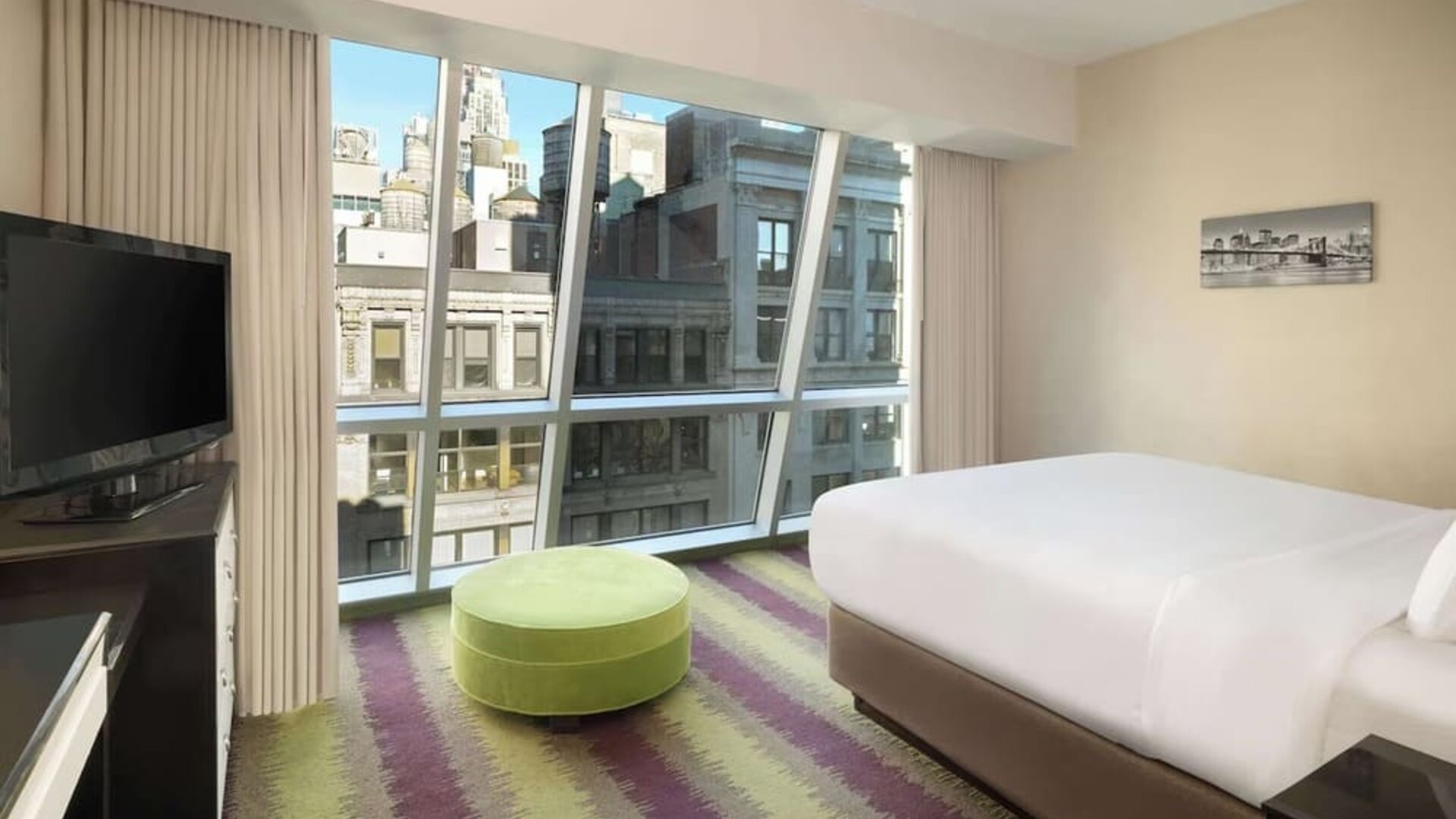Floor-to-ceiling windows in a day use room at Best Western Premier Herald Square.