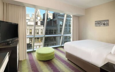 Floor-to-ceiling windows in a day use room at Best Western Premier Herald Square.