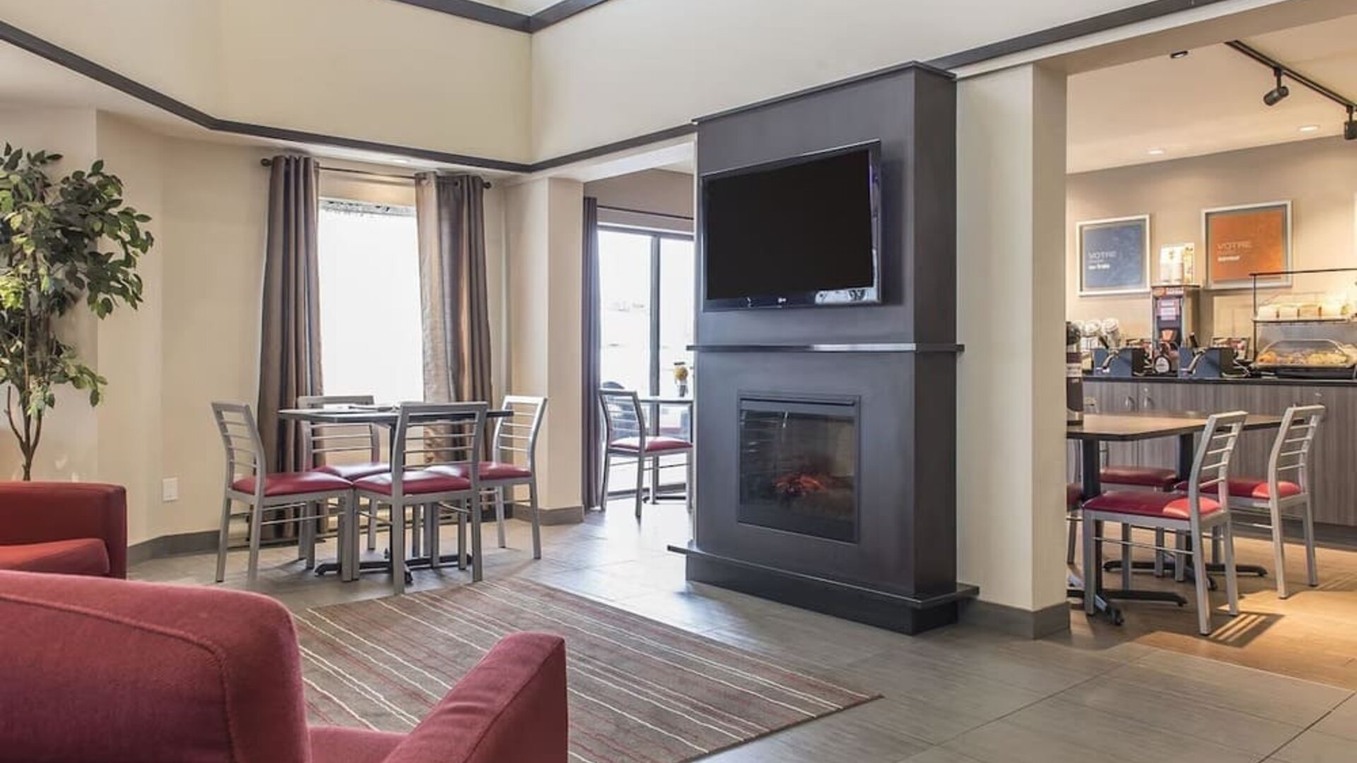 Lobby lounge with fireplace at Comfort Inn Sept-Iles. 