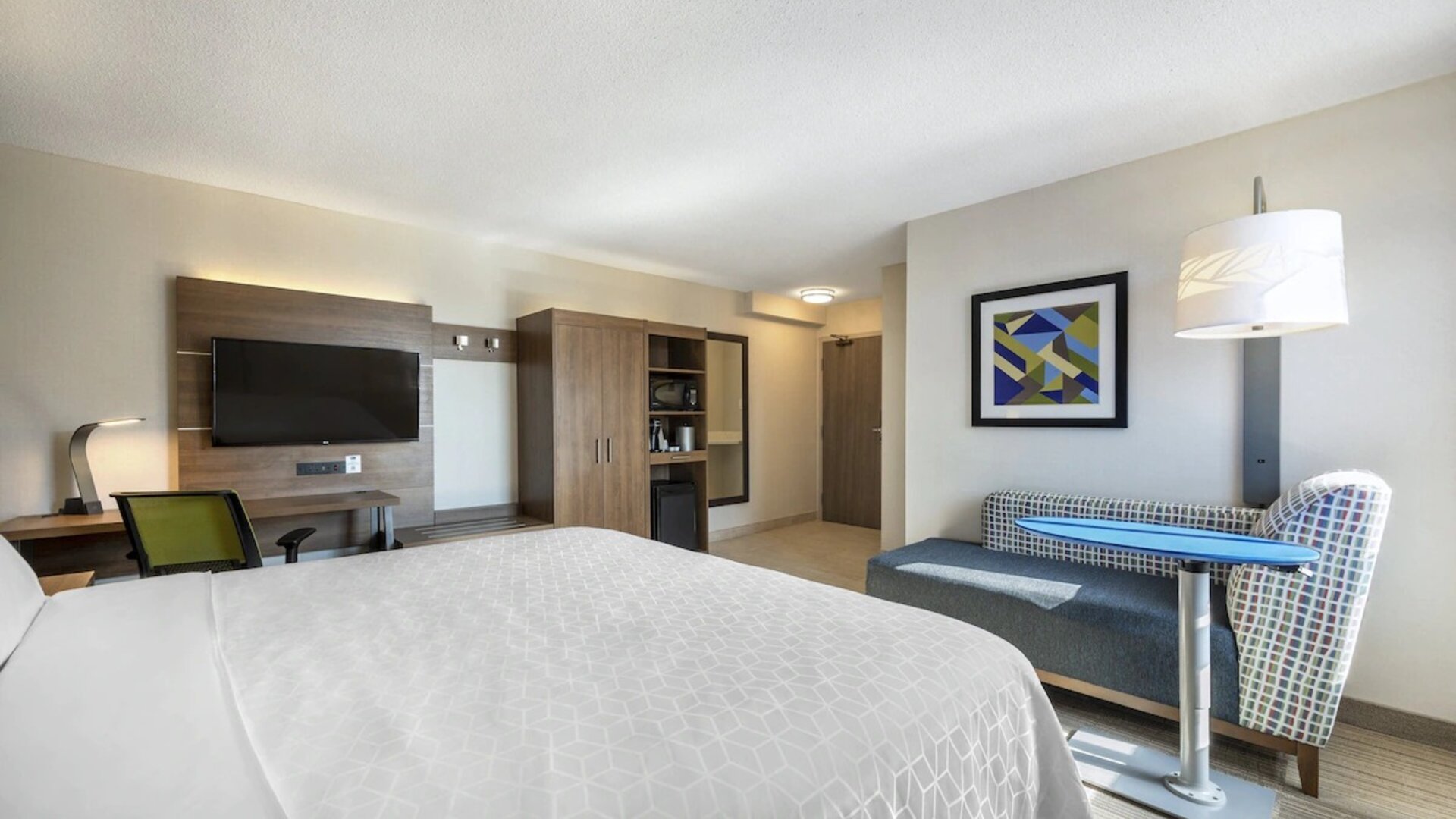 Day use room with TV, sofa, work desk and private bathroom at Holiday Inn Express Toronto Downtown.