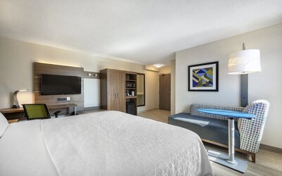 Day use room with TV, sofa, work desk and private bathroom at Holiday Inn Express Toronto Downtown.