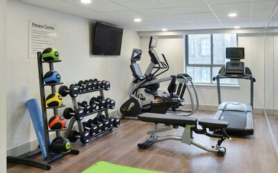 Fully equipped fitness center at Holiday Inn Express Toronto Downtown.
