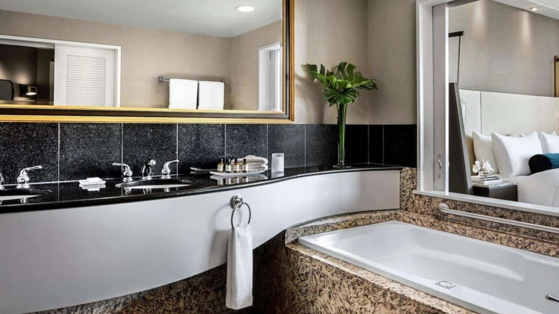 Guest bathroom with tub and free toiletries at Fairmont Vancouver Airport - YVR Terminal Hotel.