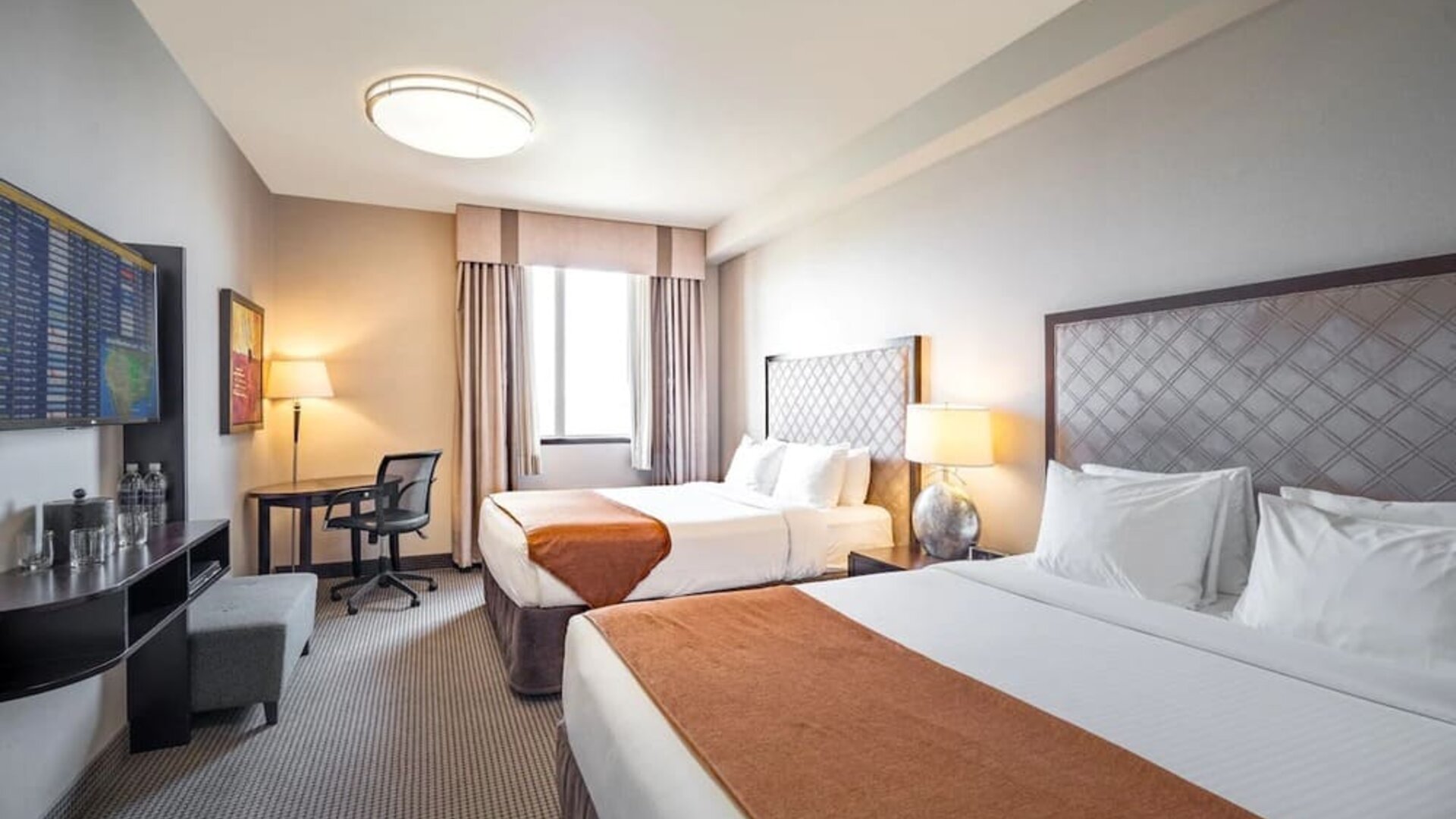 Day use twin room with work desk and private bathroom at Acclaim Hotel Calgary Airport.