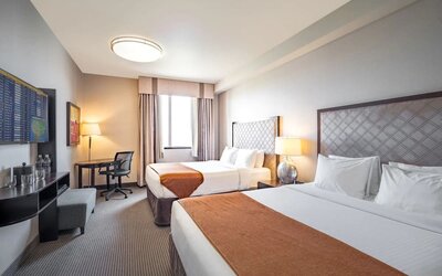 Day use twin room with work desk and private bathroom at Acclaim Hotel Calgary Airport.