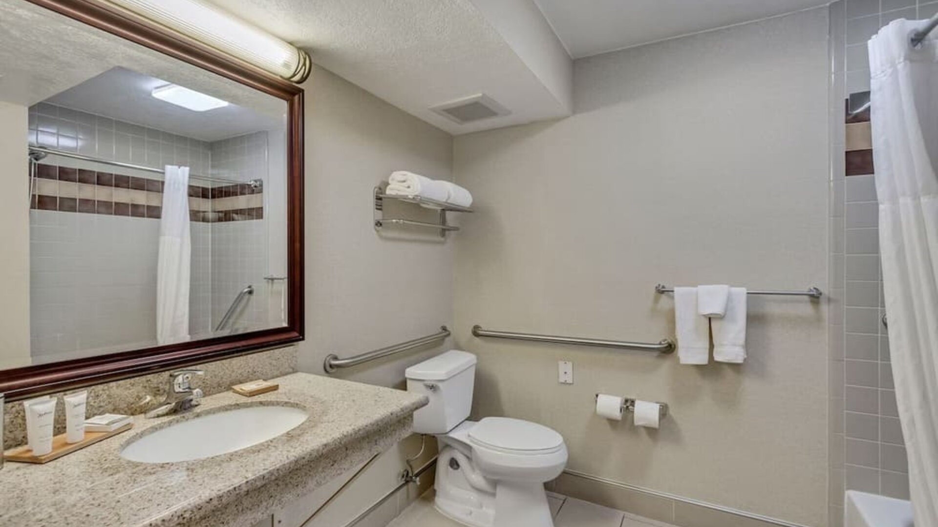 Guest bathroom with shower and tub at Radisson Hotel Salt Lake City Airport.