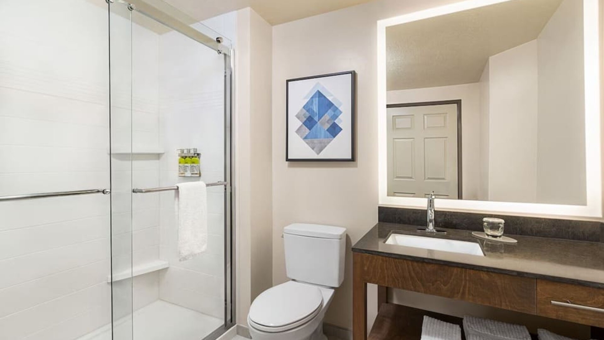 Guest bathroom with shower at Candlewood Suites Meridian.