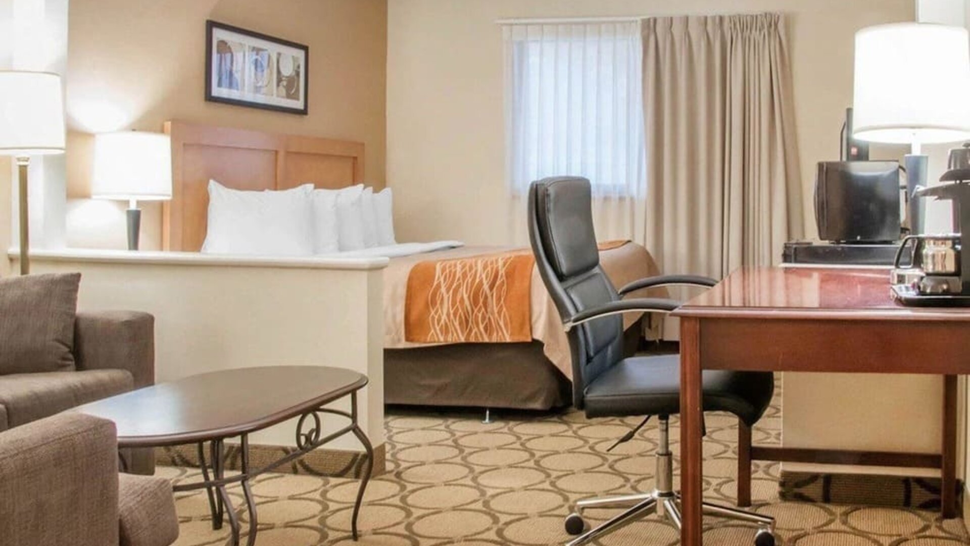 Day use suite with work desk and living area at Comfort Inn Winnipeg II South.