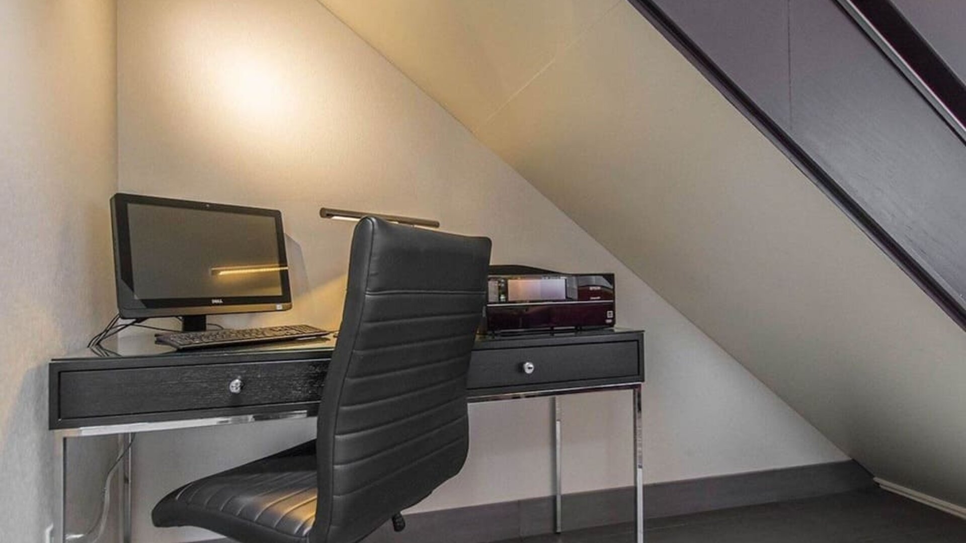 Business center with computer, printer and ergonomic chair at Comfort Inn Val D'or. 