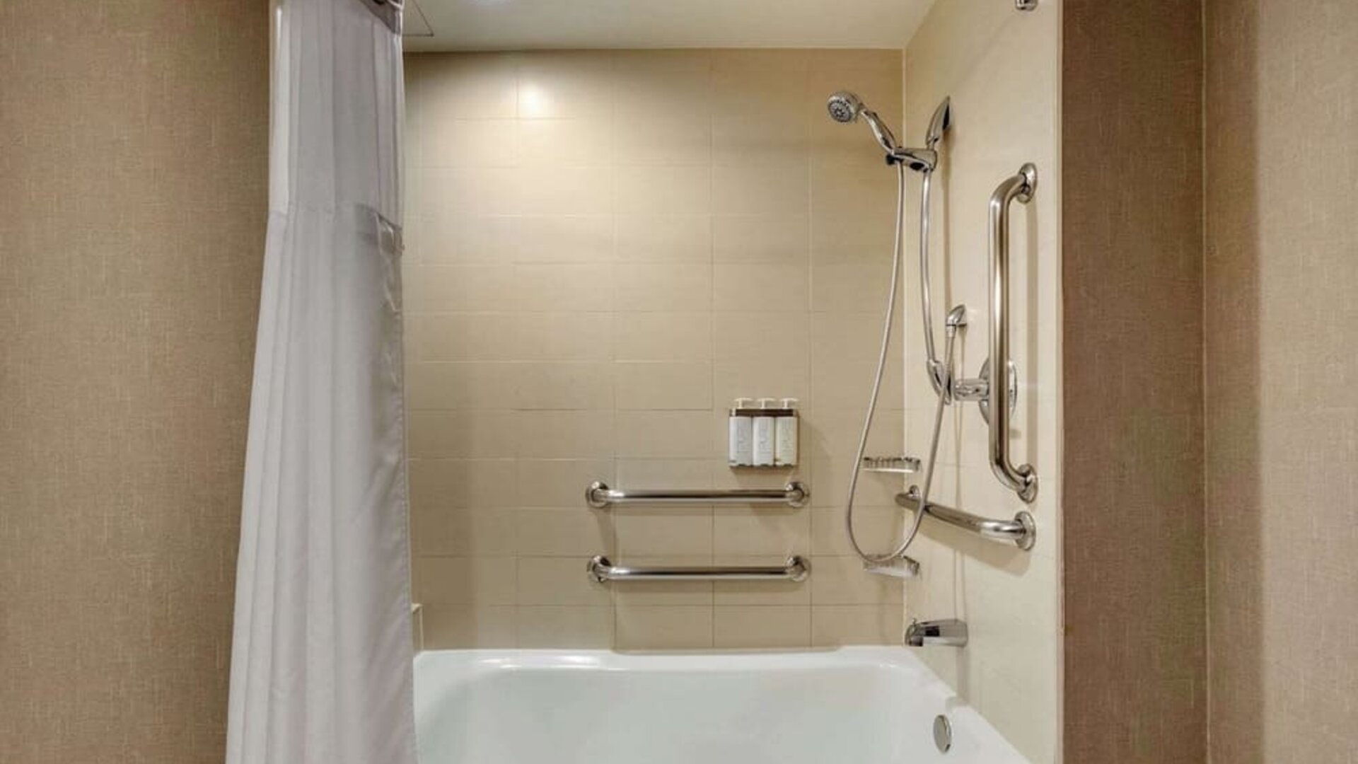 Guest bathroom with shower and tub at Cambria Suites Denver Airport.