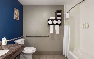 Guest bathroom with shower and tub at La Quinta Inn & Suites - North Stone Oak.