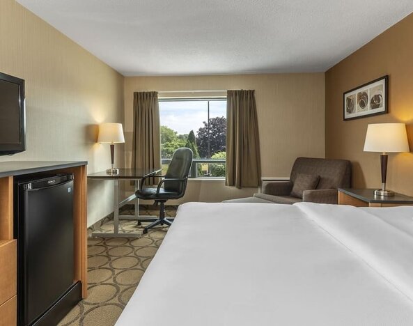 Day room with TV, work desk, sofa and private bathroom at Comfort Inn Prince Albert.