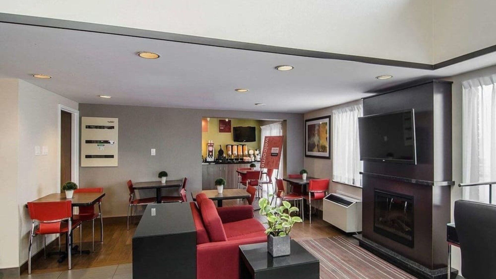 Lobby lounge with TV screen and fireplace at Comfort Inn Prince Albert.