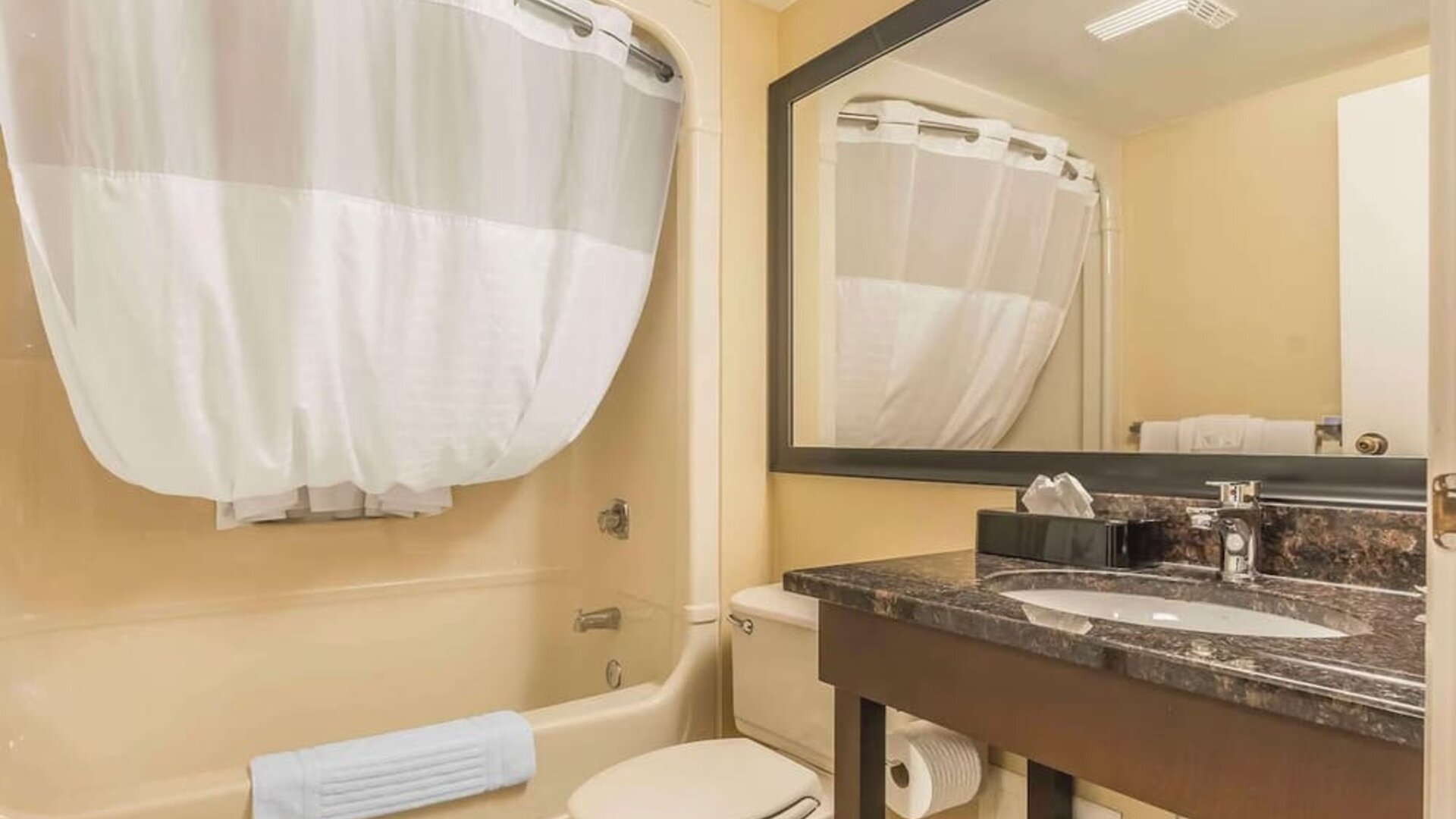 Guest bathroom with tub and free toiletries at Comfort Inn Cobourg.