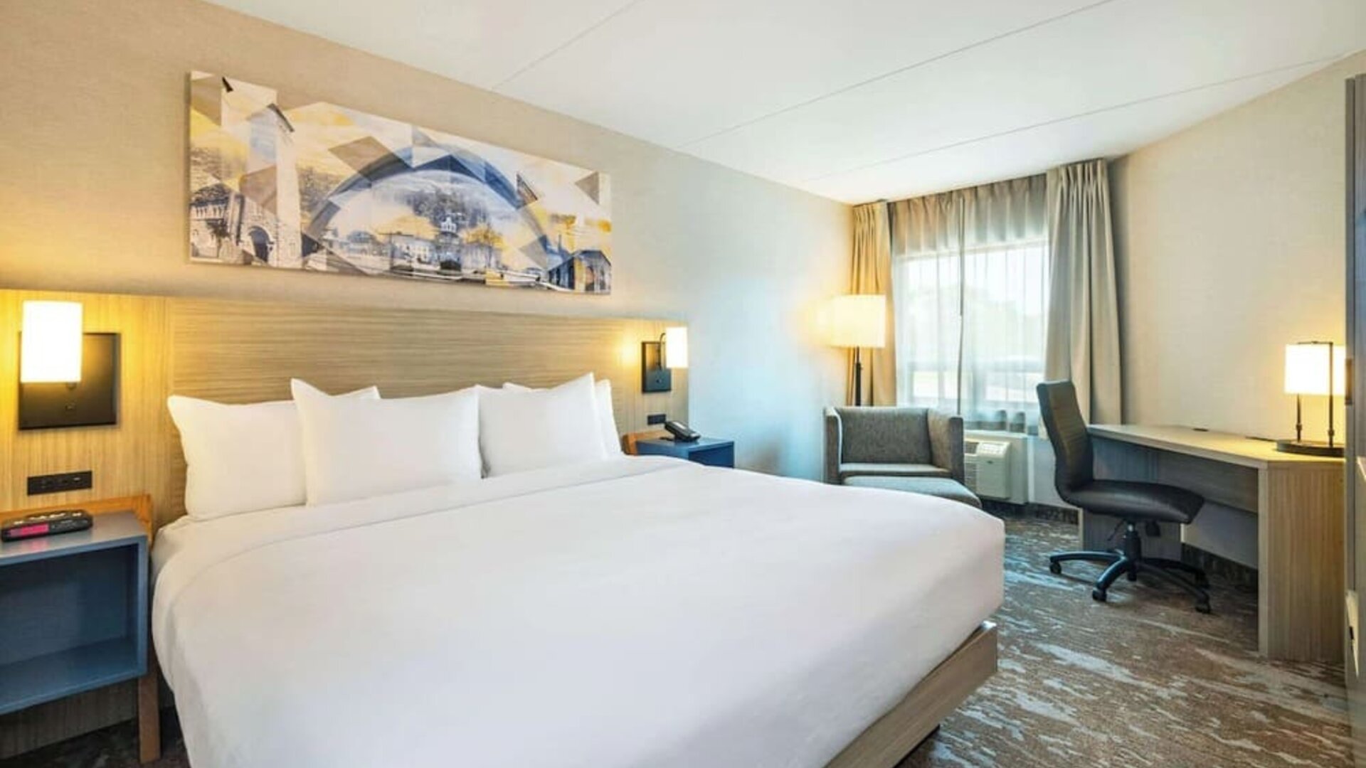 Bright and spacious day use room with work desk and sofa at Comfort Inn Kingston HWY 401.