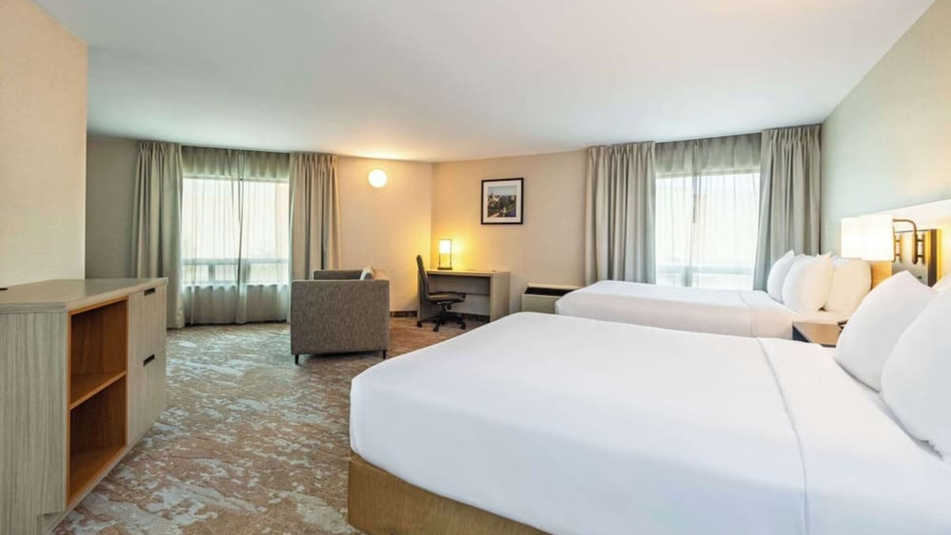 Bright and spacious day use twin room with work desk at Comfort Inn Kingston HWY 401. 