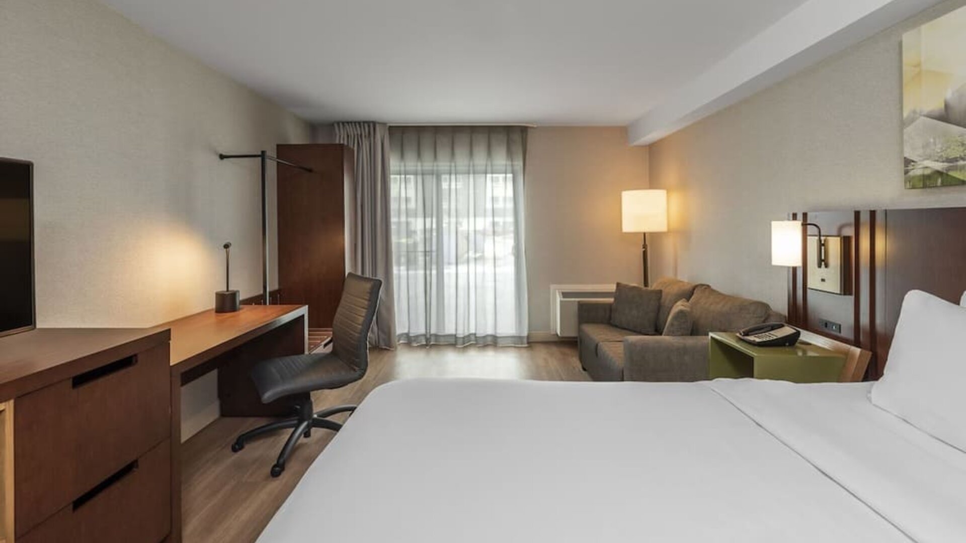 Day use room with TV, work desk and sofa at Comfort Inn Dryden.