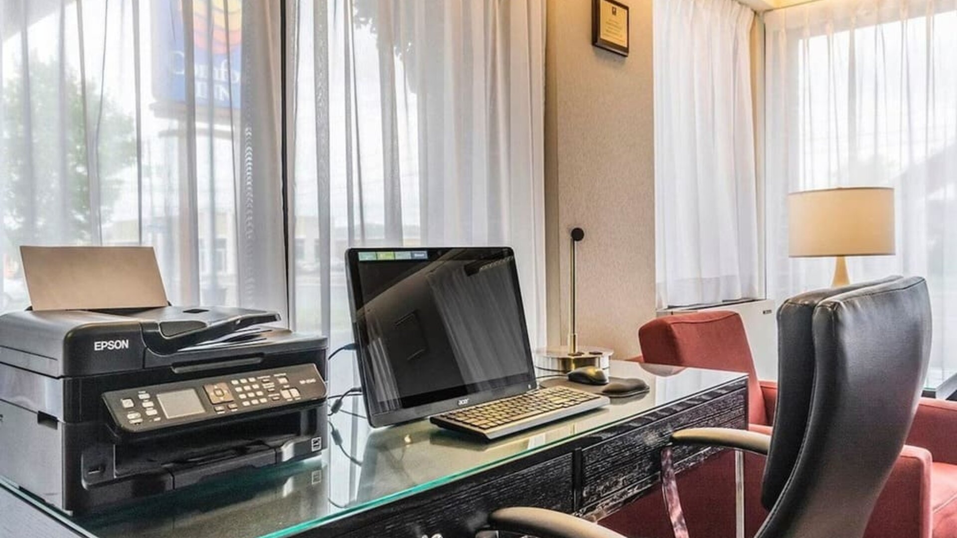 Business center with computer, printer and ergonomic chair at Comfort Inn Drummondville.