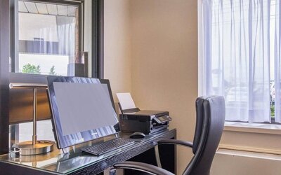 Business center with computer, printer and ergonomic chair at Comfort Inn Baie Comeau.