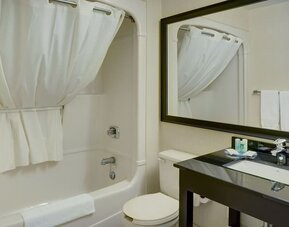 Guest bathroom with tub and free toiletries at Comfort Inn Alma.