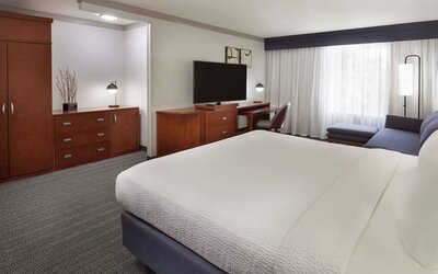 Bright and spacious day use room with TV, work desk, sofa and private bathroom at Courtyard By Marriott Waterloo St. Jacobs.