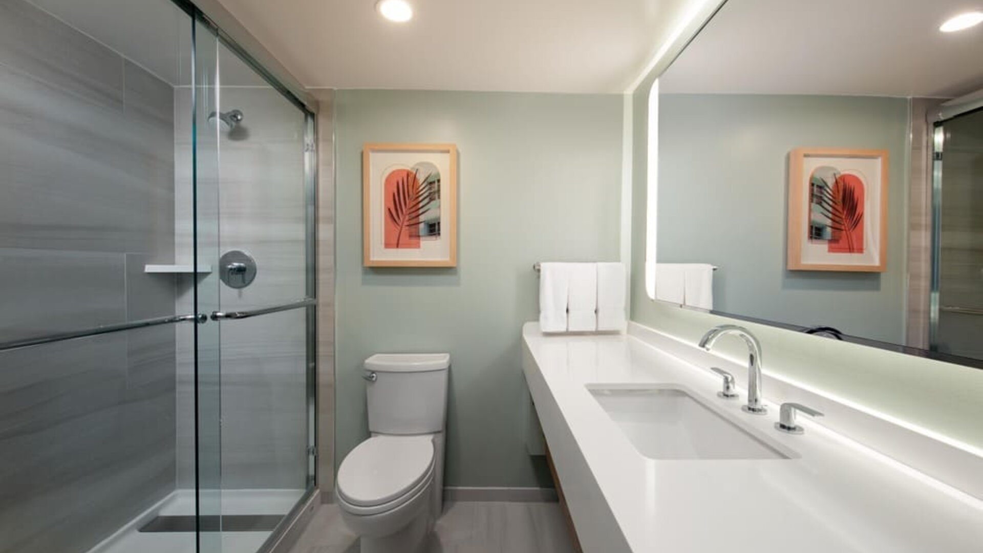Private guest bathroom with shower and free toiletries at Sonesta Miami Airport.