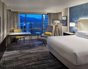 Day use room with TV, work desk and sofa at Hyatt Regency Vancouver.