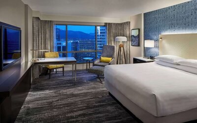 Day use room with TV, work desk and sofa at Hyatt Regency Vancouver.
