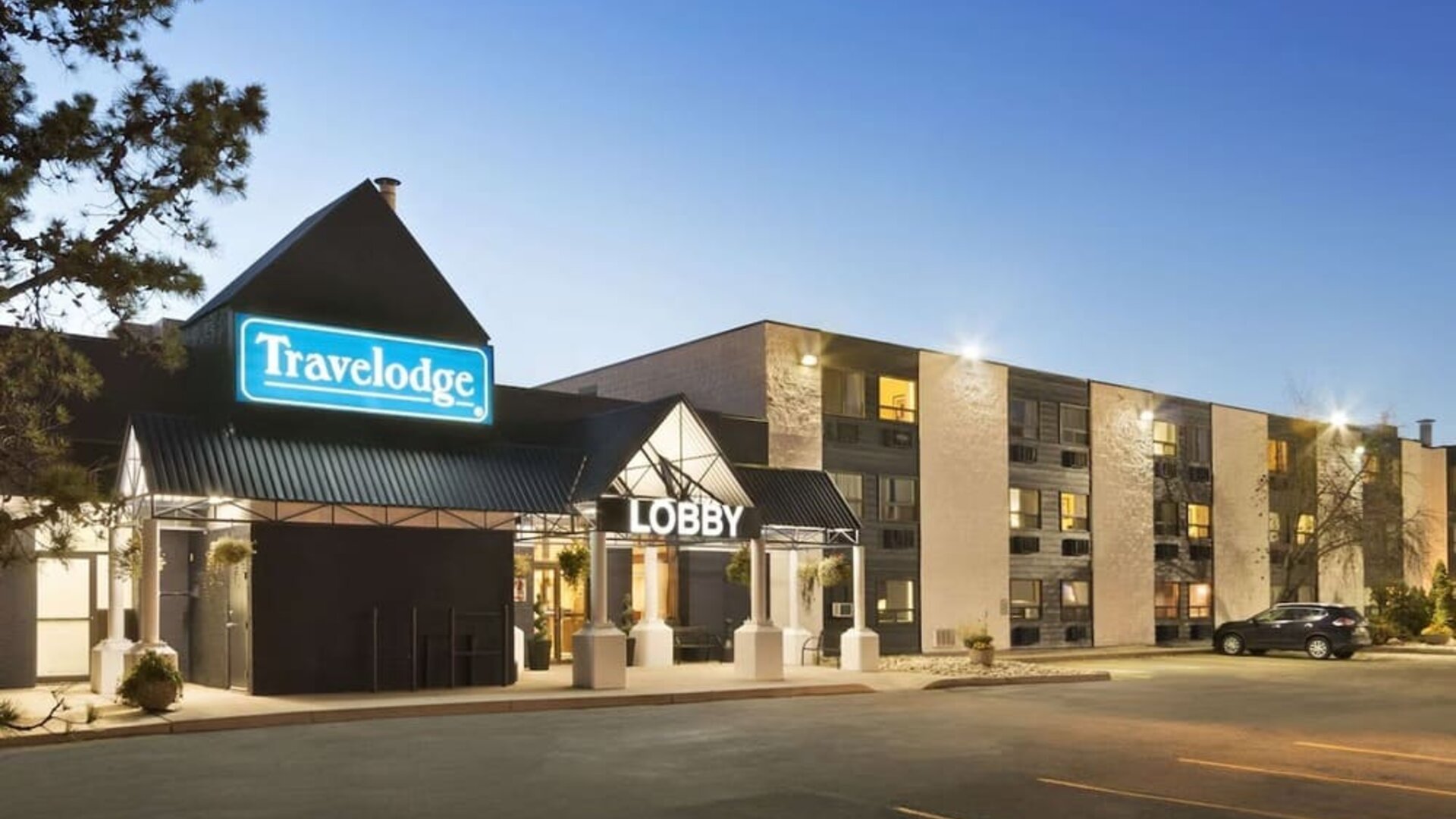 Hotel exterior and parking area at Travelodge Edmonton South.