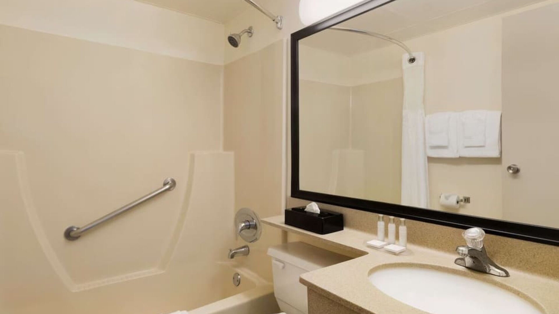 Guest bathroom with tub and free toiletries at Travelodge Edmonton South.
