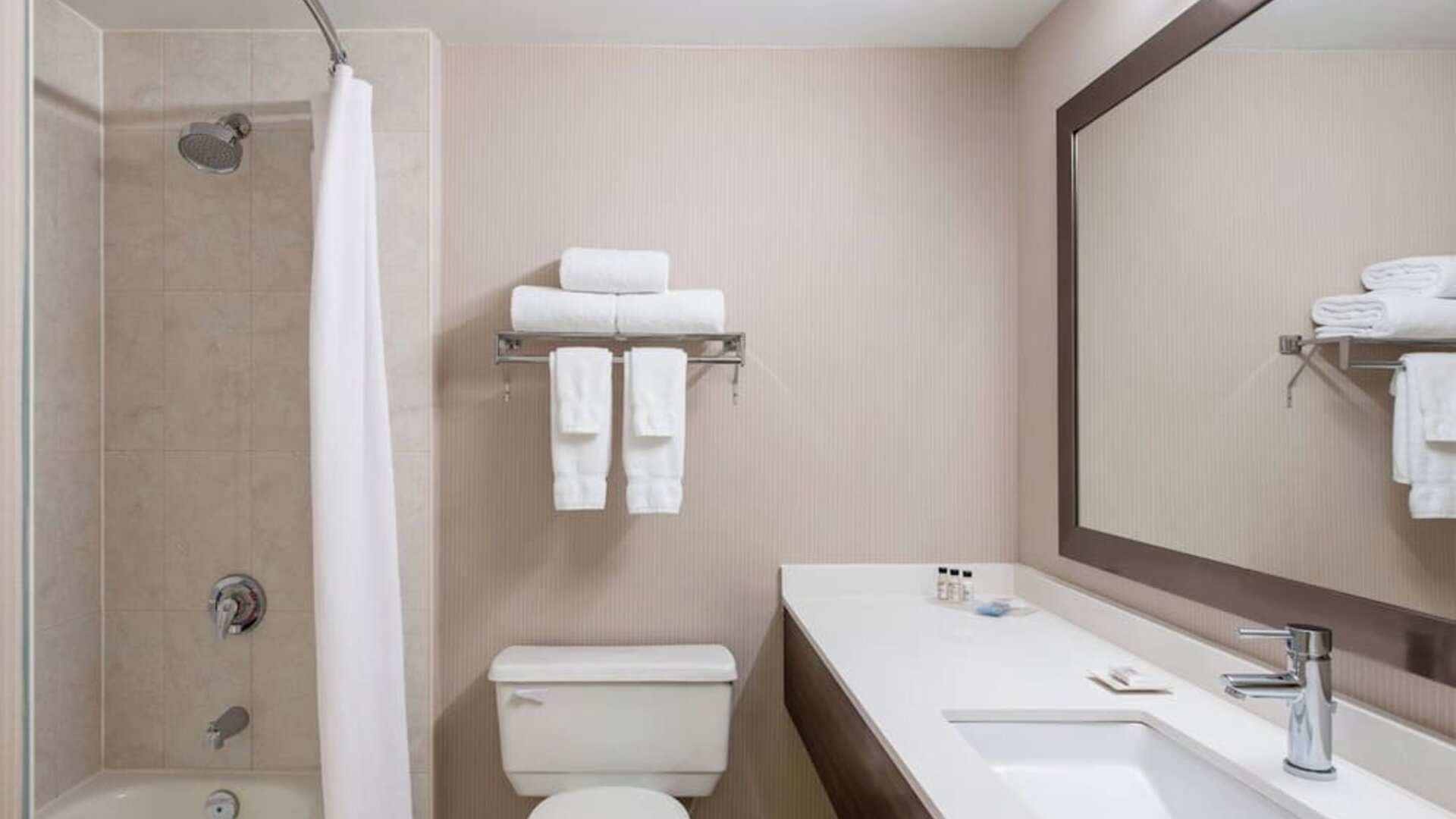 Guest bathroom with shower and tub at Delta St. John's Hotel & Conference Center.