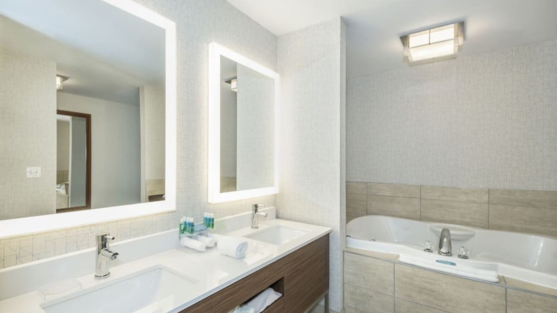 Guest bathroom with tub and free toiletries at Holiday Inn Express & Suites Medicine Hat.