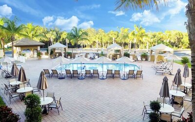 Sun loungers surrounding the pool at Holiday Inn Express & Suites Naples Downtown - 5th Avenue.