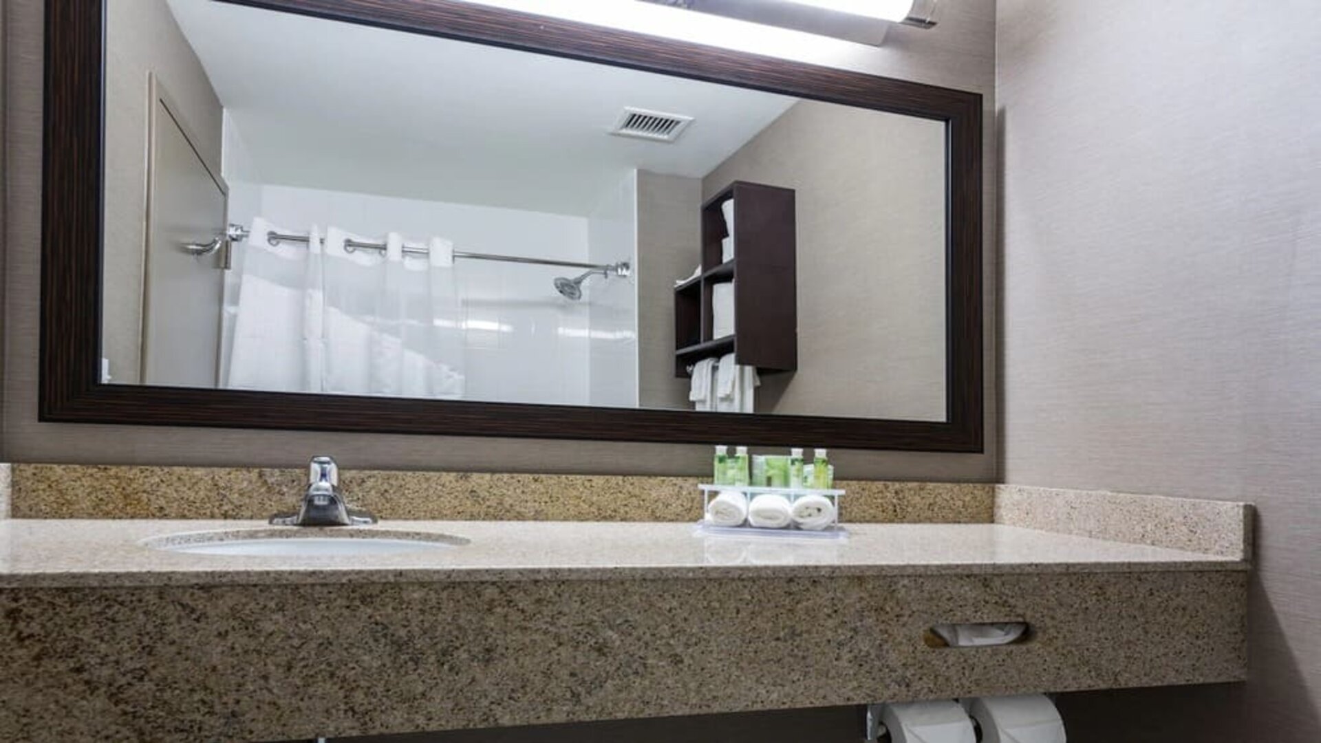 Guest bathroom with shower at Holiday Inn Express & Suites Naples Downtown - 5th Avenue.