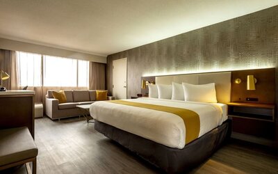 Bright and spacious day use room with lounge area and work desk at Atlantica Hotel Halifax.