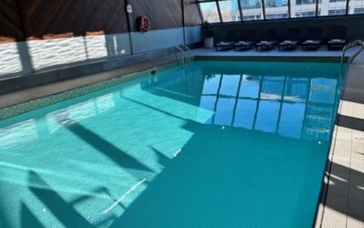 Relaxing indoor pool with lounge chairs at Atlantica Hotel Halifax.