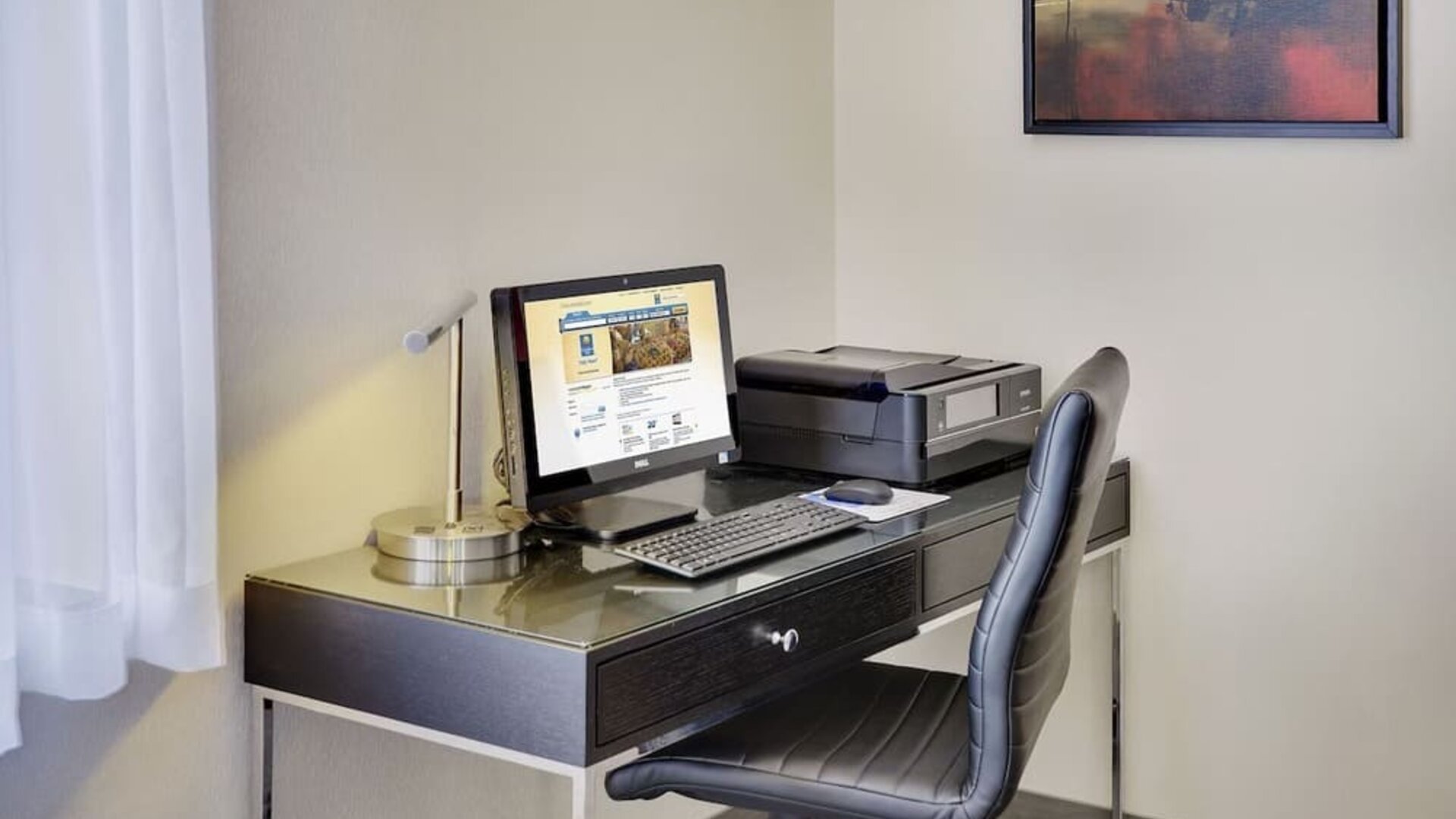 Business center with computer, printer and ergonomic chair at Comfort Inn Gatineau.
