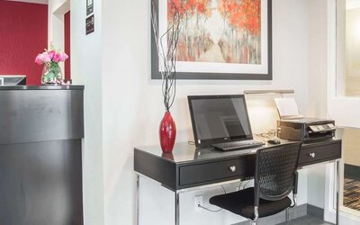 Business center with computer, printer and ergonomic chair at Comfort Inn Fredericton.