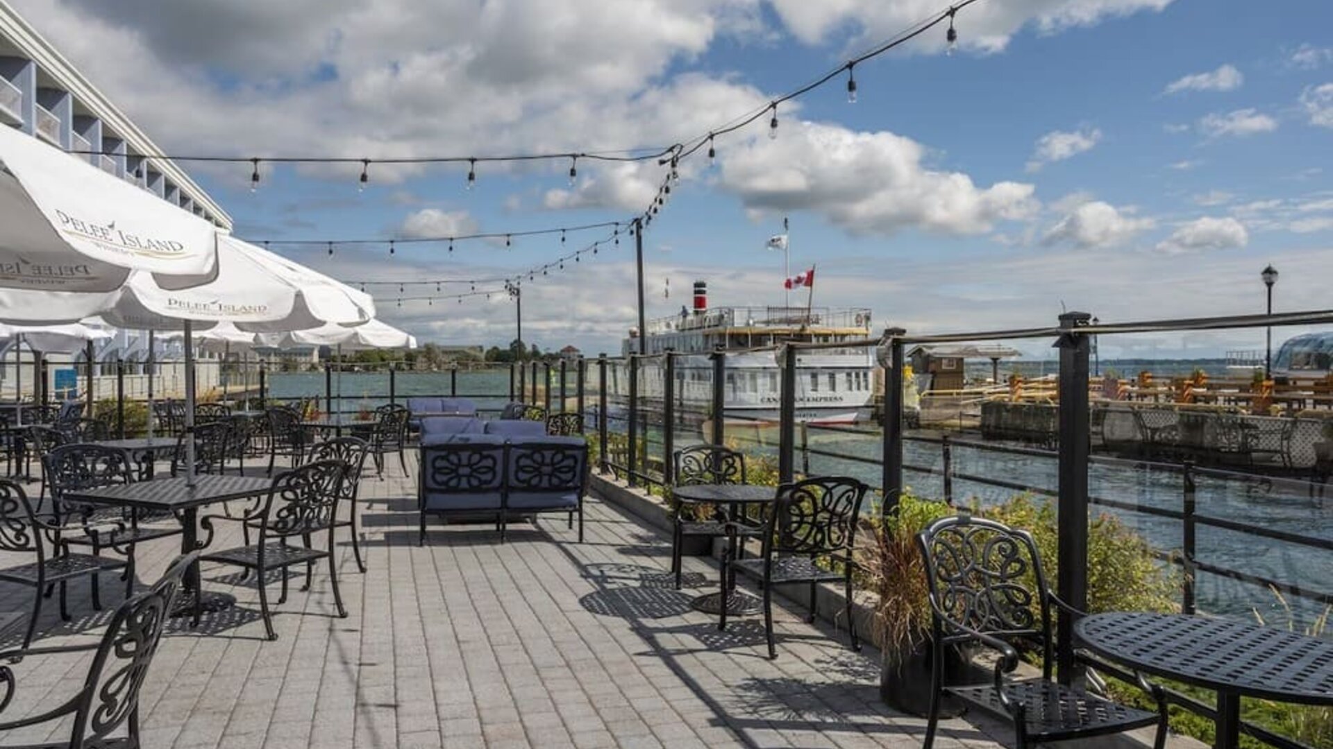 Terrace sitting area with waterfront view at Holiday Inn Kingston Waterfront.