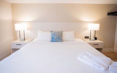 King bed at Les Suites Hotel Ottawa.