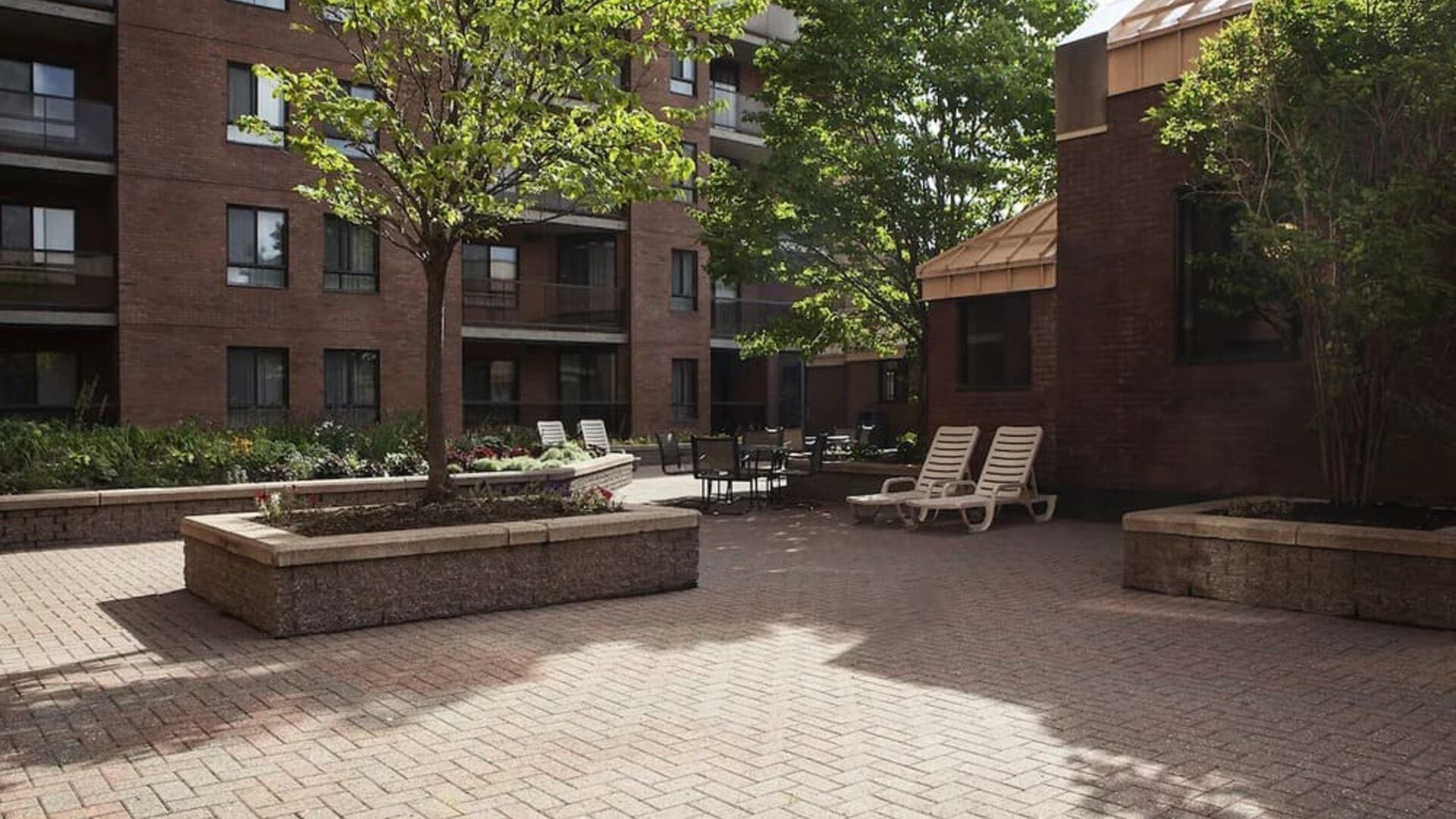 Outdoor patio with lounge seating at Les Suites Hotel Ottawa.