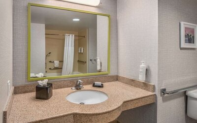 Guest bathroom with shower and tub at Hampton Inn & Suites Dallas/Allen.