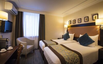 Day use twin room with TV, sofa and coffee maker at Thistle London Heathrow Terminal 5.