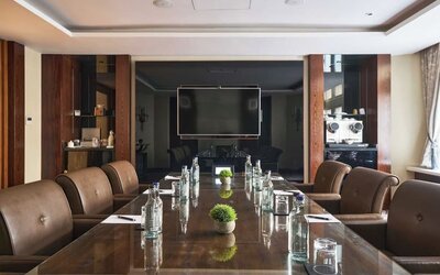 Professional meeting room with comfortable seating and TV screen at The Royal Horseguards Hotel.